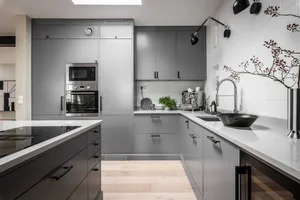 Modern contemporary kitchen featuring gray cabinets and white countertops with a sleek, minimalist design and a touch of indu