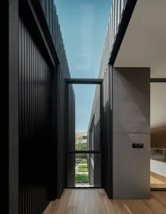 Modern interior design featuring glass walls and doors.