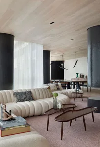 Modern living room featuring a plush fabric couch and contemporary coffee tables.