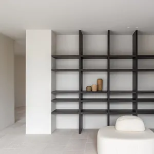 A modern, minimalist bookshelf with wooden shelves and decorative vases.