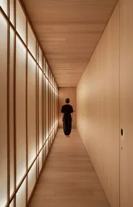 A minimalist interior space featuring wooden walls and floor