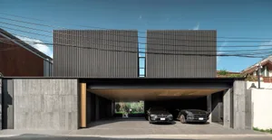 Modern residential architecture featuring dark wood and concrete materials