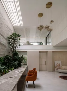 A minimalist living room featuring concrete, marble, and wooden elements.