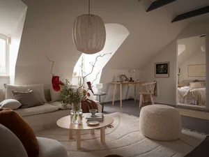 A minimalist living room with natural materials such as wood, fabric, and glass.