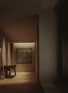 A modern corridor featuring wood plank flooring, soft lighting, and minimalist decor.