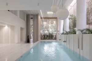 Modern minimalist residential area with a white marble pool on a clean, white marble floor.