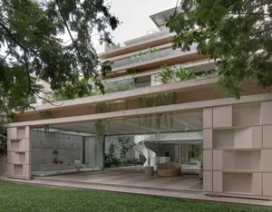 Modern, minimalist residential exterior with concrete, glass, and hanging plants