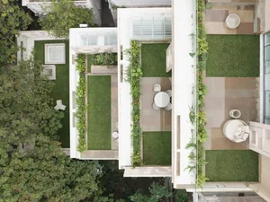 Modern residential patio featuring concrete and green turf surfaces
