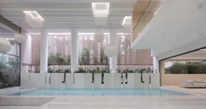 A modern swimming pool with minimalist design and concrete terraces.