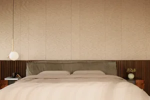 Modern minimalist bedroom with beige fabric bedding, wooden headboard, and white pendant light.