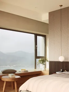 Modern minimalist bedroom featuring wood, glass, and fabric materials and textures.