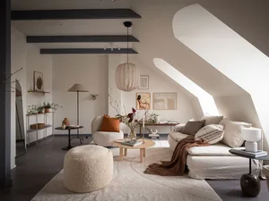 A minimalist living room featuring neutral materials and a cozy atmosphere.