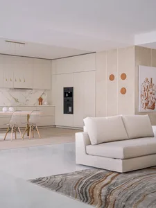 Modern interior living space featuring neutral marble colors and minimalist furniture