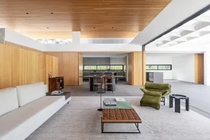 Minimalist living room with wood accents and modern furniture.