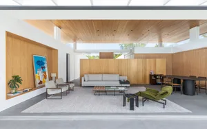 Modern residential interior featuring a contemporary wood design with a white ceiling, gray flooring, and a large window.