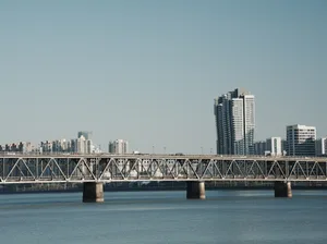 Modern bridge featuring metal construction spanning a body of water