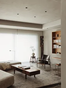 Contemporary living room featuring wooden furniture, leather accents, and a cozy ambiance.