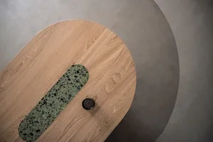 A modern table design featuring a wooden surface and a green marble base.