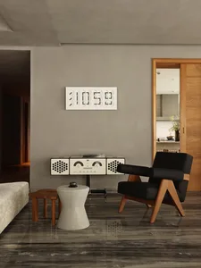 Modern minimalist living room featuring concrete surfaces, a black armchair, and a stylish side table.