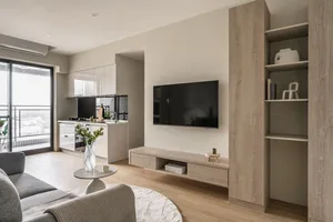 A modern minimalist living room featuring wood, glass, and metal materials.