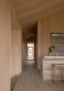 A minimalist residential interior featuring wood and porcelain tile