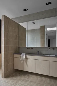 Modern minimalist bathroom featuring tile and concrete surfaces.