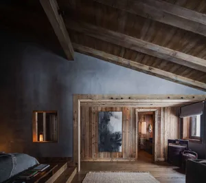 Industrial-style residential interior with wood materials and vaulted ceiling.