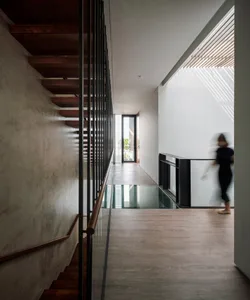 Modern interior design featuring stairs made of wood, metal, and concrete materials.