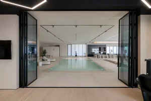 A modern, industrial residential interior with a concrete floor and minimalist design.