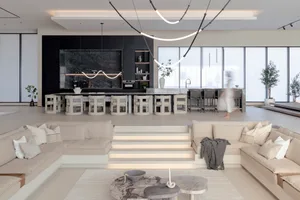 A modern living room with neutral tones, featuring spacious seating and a minimalist design.