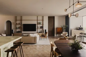 Modern living room featuring wooden flooring and furniture, with a minimalist design aesthetic.