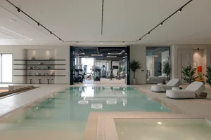 Modern, minimalist gym and swimming pool concept with sleek, clean lines and a neutral color palette.