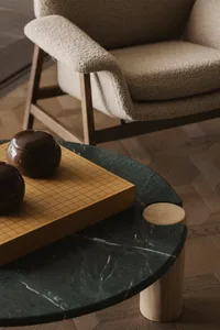 A modern marble coffee table with wooden accents and a Go board.