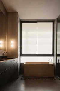 Modern minimalist bathroom featuring a wooden soaking tub and concrete floor and walls