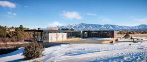 Modern residential home with concrete, glass, and metal exterior materials.