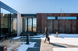 A sleek modern exterior with a metallic finish and large glass windows.