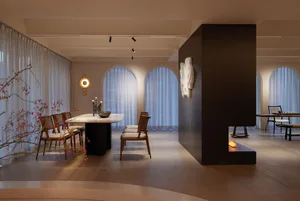 A modern dining room with sleek furniture and minimalist design elements.