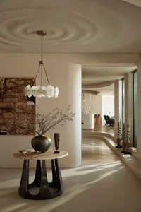 An elegant entrance featuring a modern design with marble and concrete materials.