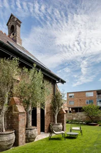 A modern residential exterior with brick, glass, and metal accents.