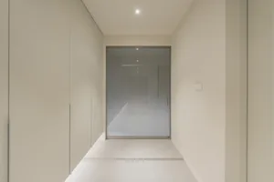 Modern hallway with glass walls and concrete floor