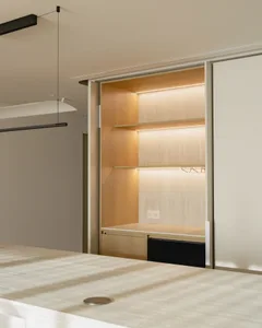 Modern minimalist closet featuring wood shelves with hidden lighting and a sleek, clean design.