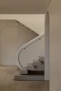 Modern staircase with concrete steps and minimalist design.