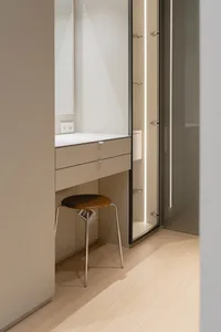 A minimalist bathroom featuring glass panels, modern design, and a sleek, uncluttered atmosphere.