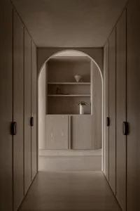 A minimalist interior with wooden cabinets and shelves, featuring simple and elegant design elements.
