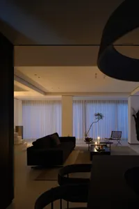 A modern living room with textured curtains and ceiling.