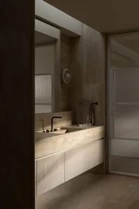 Modern bathroom with marble sink and countertop, featuring a towel rack and a mirror above the sink.