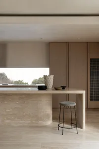 A modern kitchen featuring marble surfaces and minimalist design.