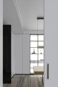 Modern minimalist residential interior with metal accents and sleek design elements.