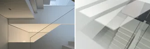 A modern staircase with timber and glass elements. The sunlight casts shadows on the wall, highlighting the sleek, minimalist