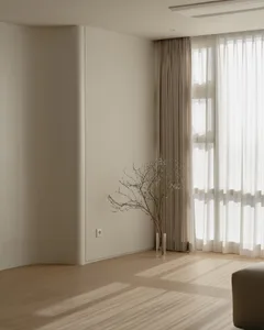 A minimalist interior with neutral tones features a simple, elegant room with white walls, beige curtains, and a single plant